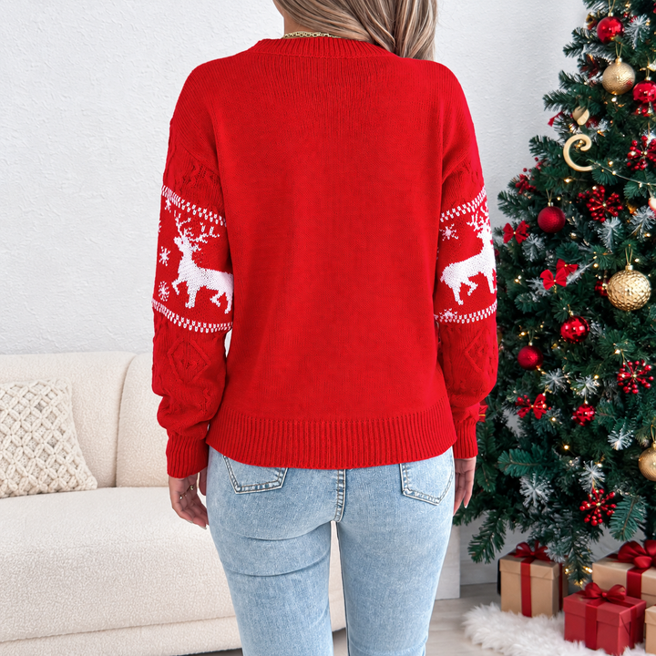 Red cable-knit Christmas sweater from behind, showing the plain back and reindeer-patterned sleeves.