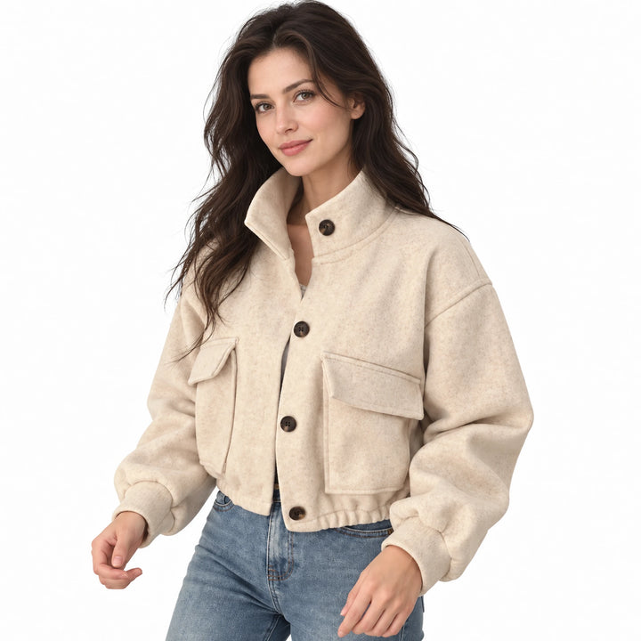 Adult model wearing a beige cropped button jacket with a stand collar and flap pockets