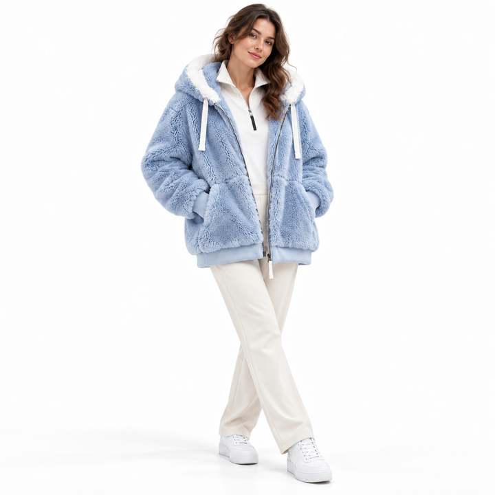 Blue hooded jacket on model with textured surface, front zipper and pockets