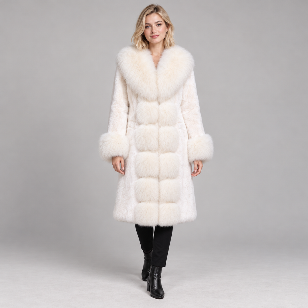 White long-sleeve coat with wide pile collar and cuffs, worn by a full-body model in a gray studio.