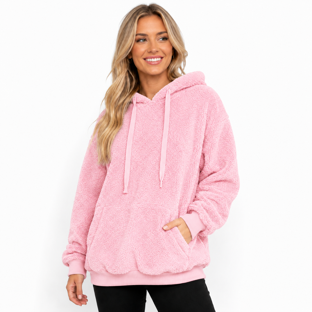 Pink hooded fleece pullover shown on a studio model with long drawstrings, kangaroo pocket, cuffs and clean white background.