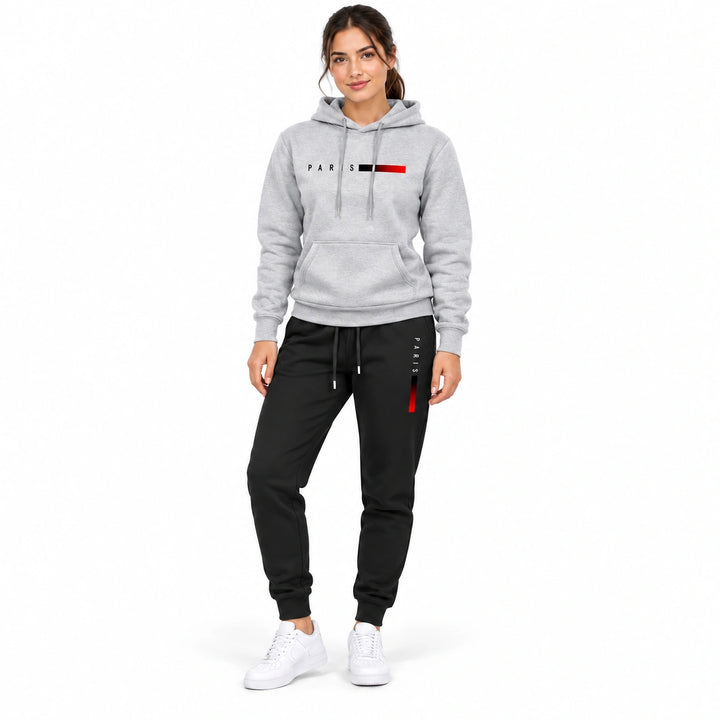 Woman wearing the light gray PARIS hoodie and black PARIS pants set on a white background