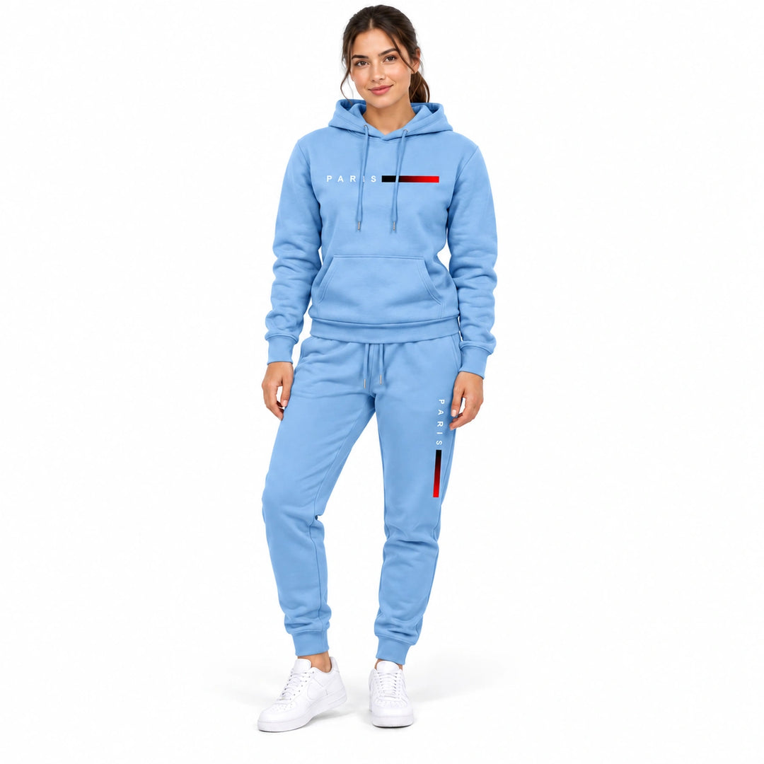 Woman wearing the light blue hoodie and matching light blue pants set on a white background