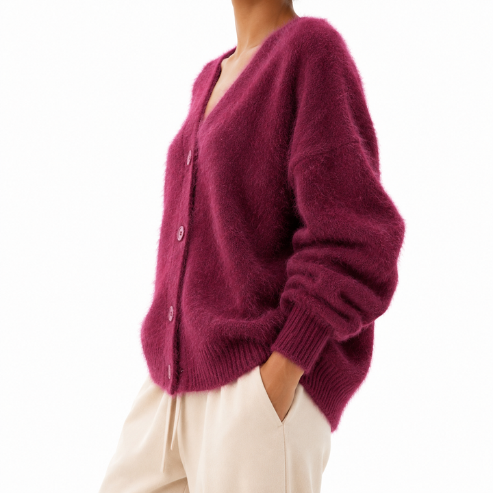 Deep magenta fuzzy cardigan in a three-quarter view, showing the V-neck button front, sleeve volume, ribbed cuffs and loose shape.