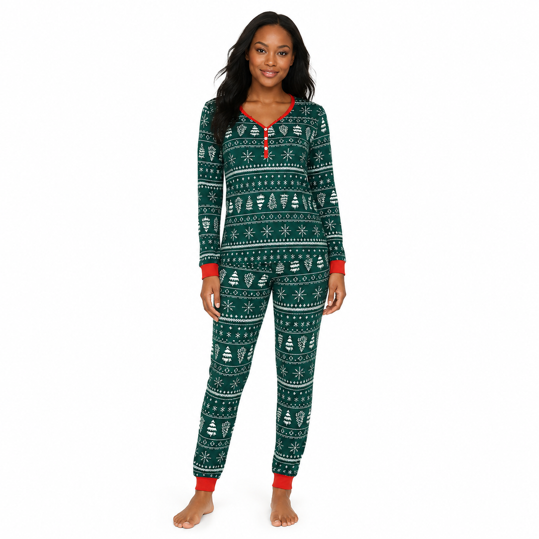 Woman wearing green Christmas pajamas with white festive print and red trim, shown from the front.