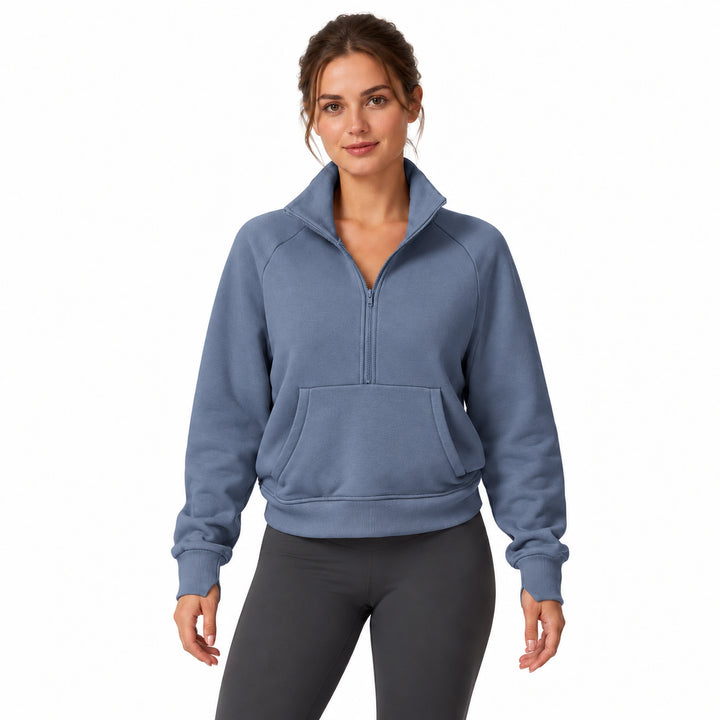 Woman wearing the Blue Grey half-zip fleece pullover, front view on a white background.