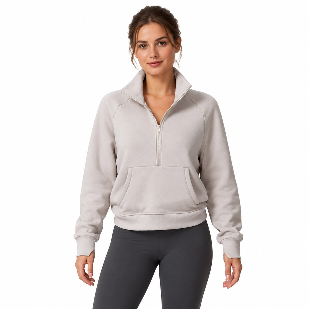 Woman wearing a linen-color half-zip fleece pullover, front view on a white background.