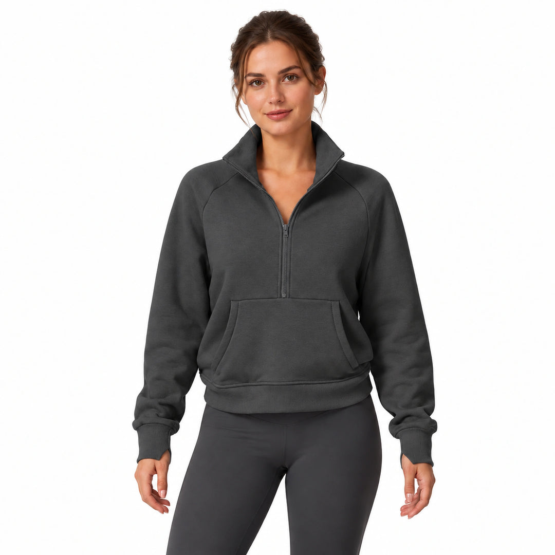 Woman wearing the volcanic ash charcoal half-zip fleece pullover, front view on a white background.