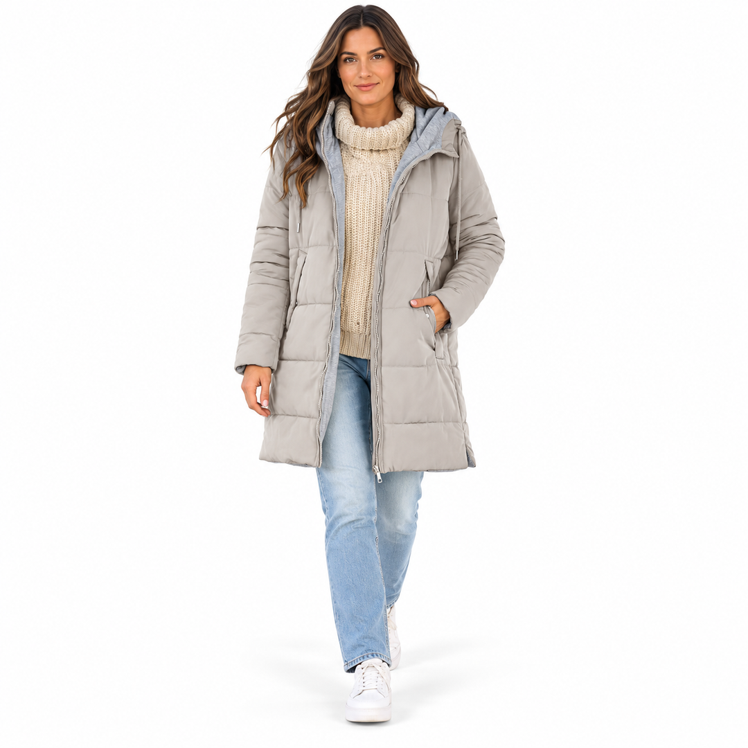 Gray White hooded jacket on a full-body adult model walking in studio styled with a cream knit and jeans on white background.