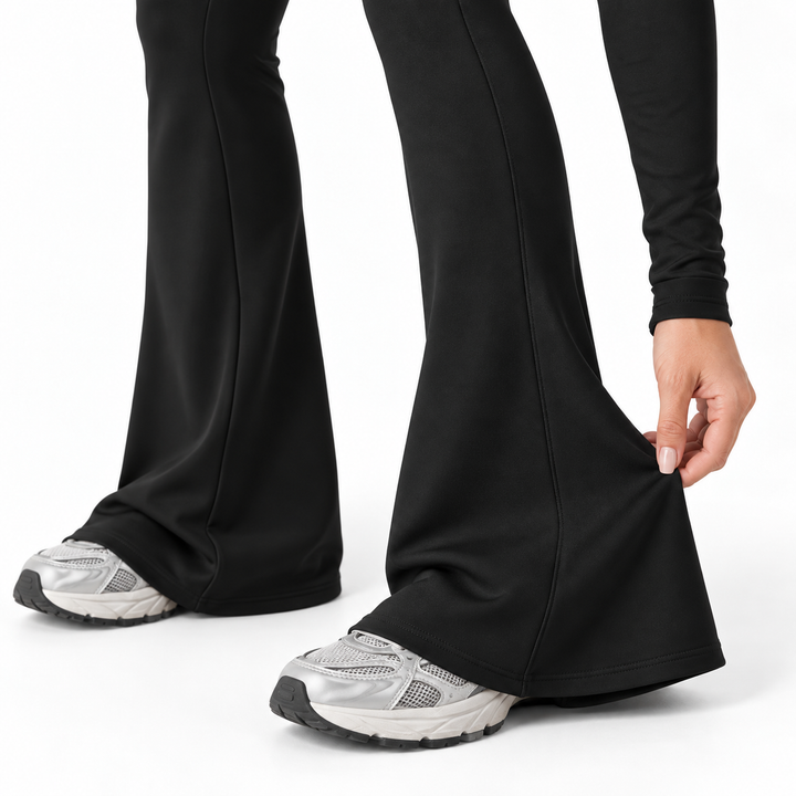 Close view of the black jumpsuit flared leg and seam detail