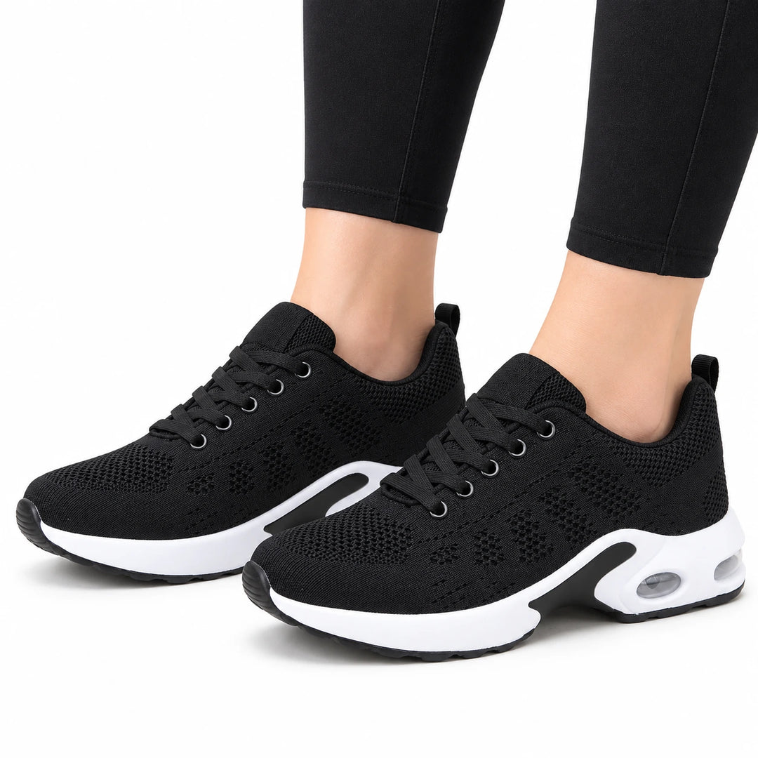 Mesh Lace-Up Sneakers in the Black option on a model against a white background
