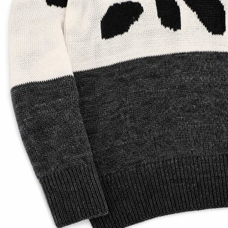 Close view of the Black and Gray leopard print sweater knit texture, color transition, ribbed cuff and lower hem.