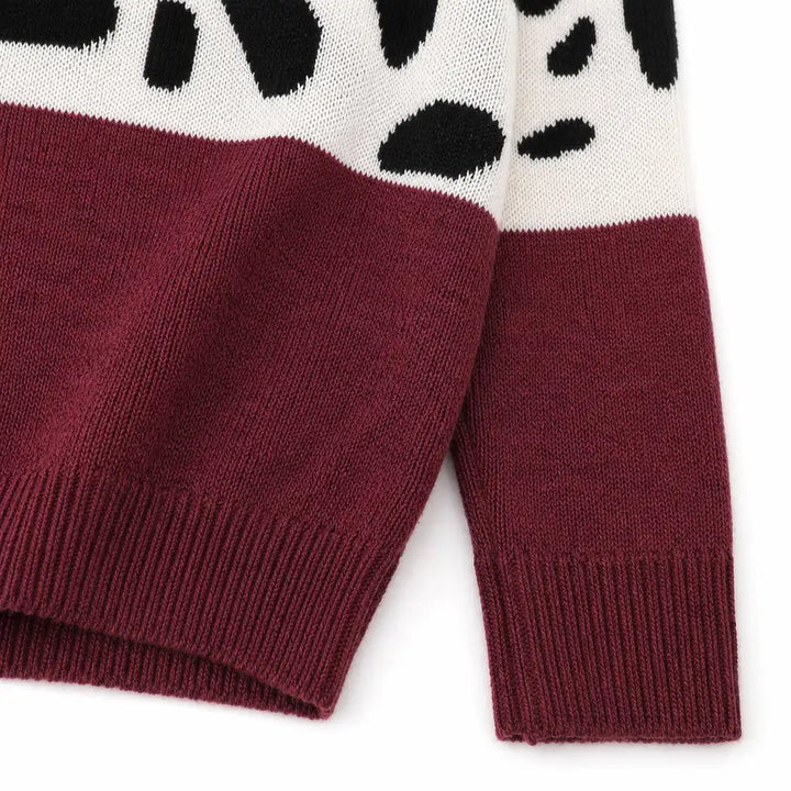 Close view of the Chestnut Red leopard print sweater knit texture, color-block transition, ribbed cuff and hem.