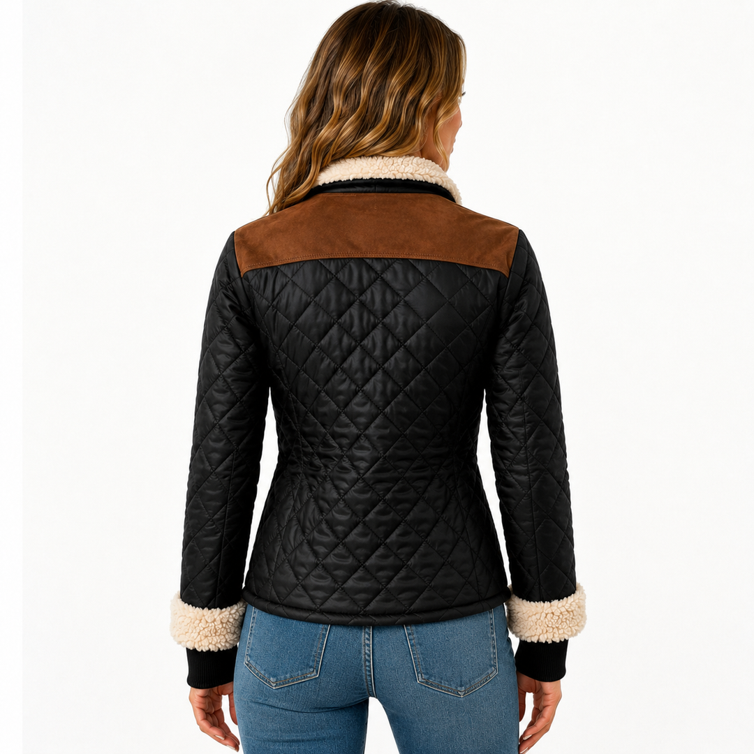 Back view of black quilted jacket on model showing diamond stitching, brown shoulder yoke, cream collar and cuff trim clearly