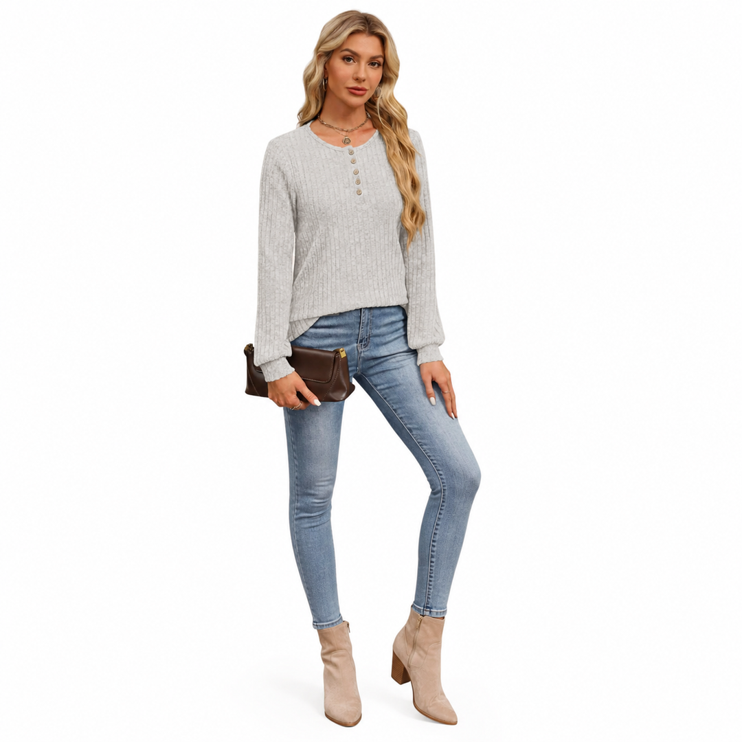 Women's ribbed long sleeve shirt in light gray shown on a model in a clean full-body front view on white background.