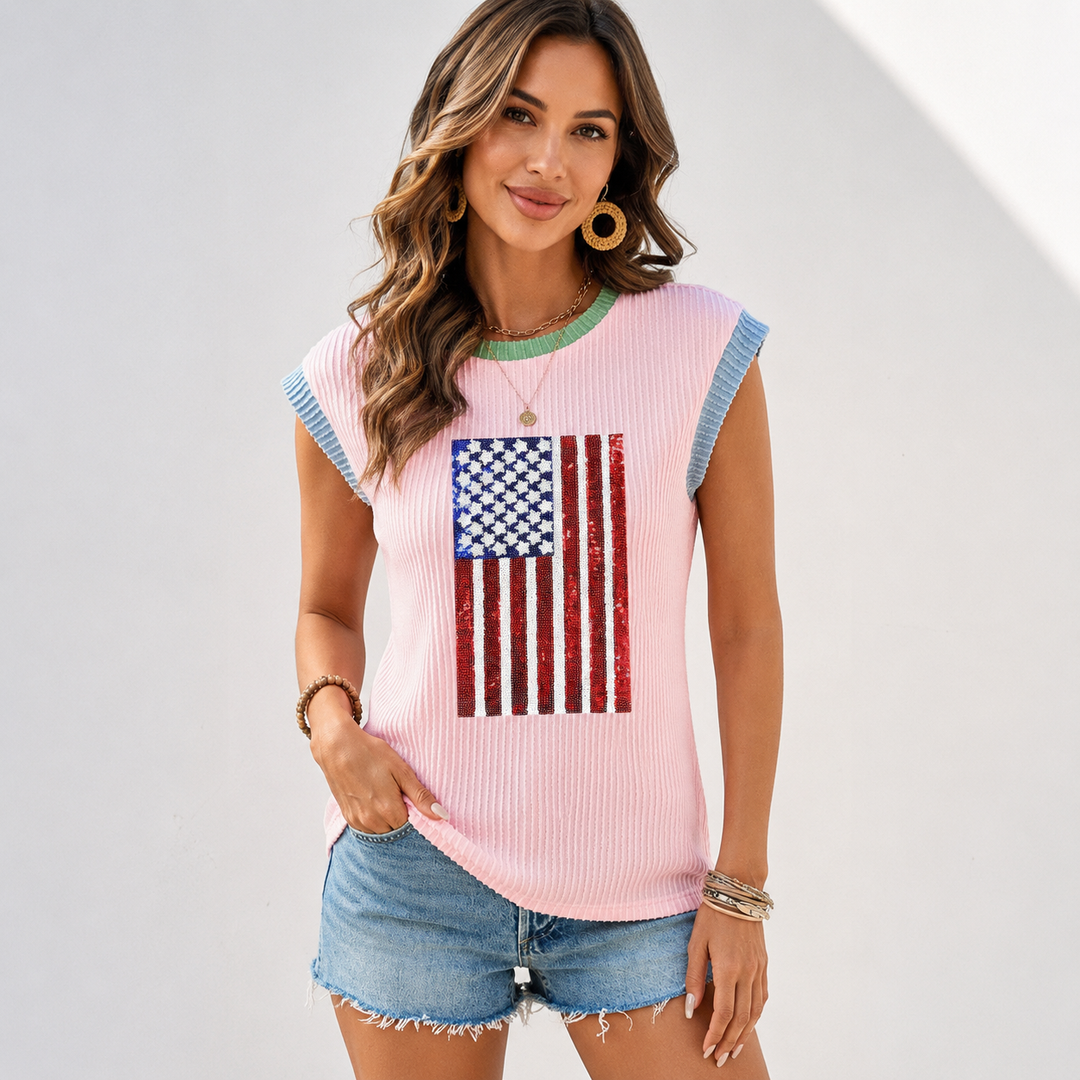 Women's sequin American flag T-shirt in blush pink, front model view showing rib texture, green neckline and blue sleeve trim