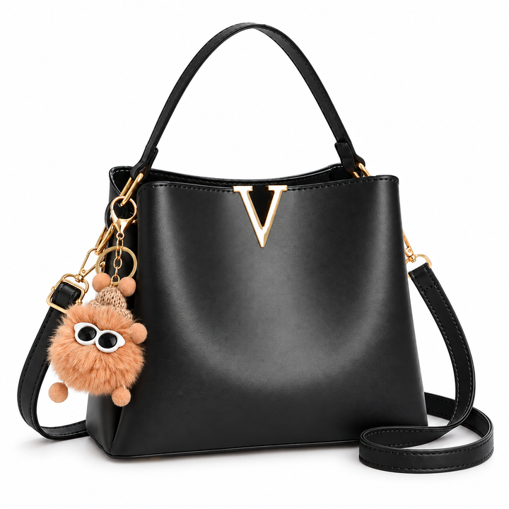 Black shoulder bag with gold V detail and fluffy charm, front view