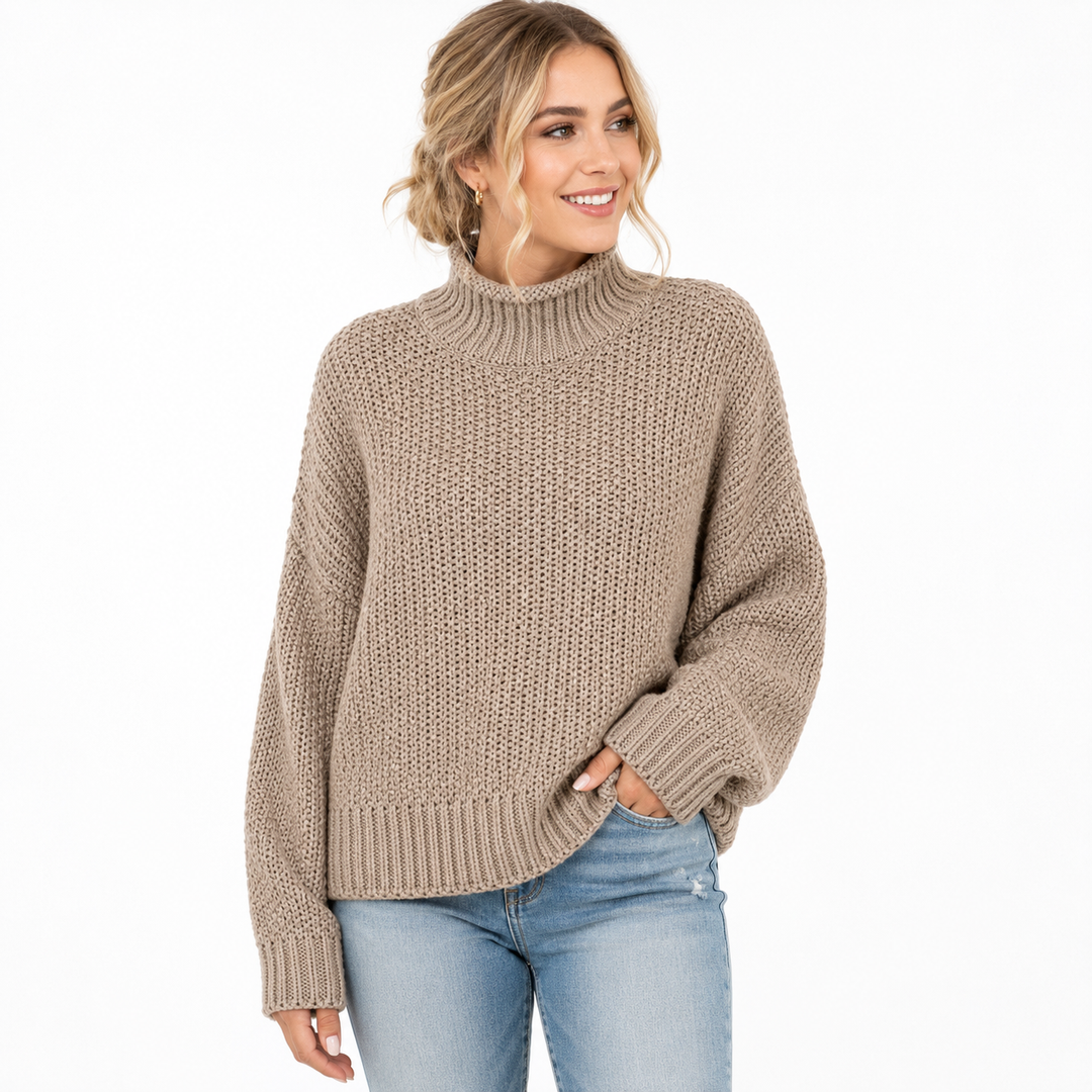 Women's taupe turtleneck sweater on model with textured knit and ribbed details on a clean white studio background.