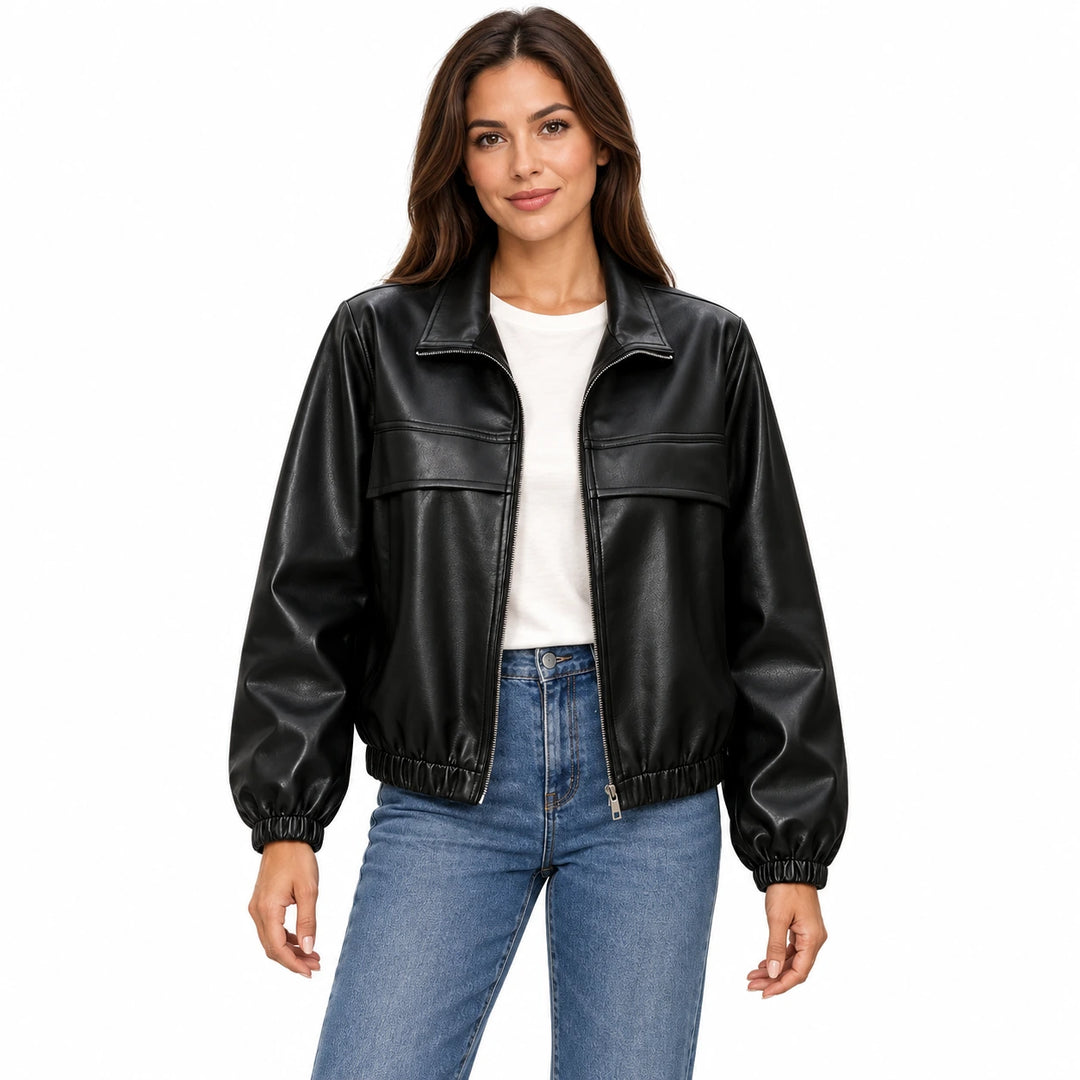 Woman wearing the Black faux leather jacket with an ivory T-shirt and blue jeans on a white background.