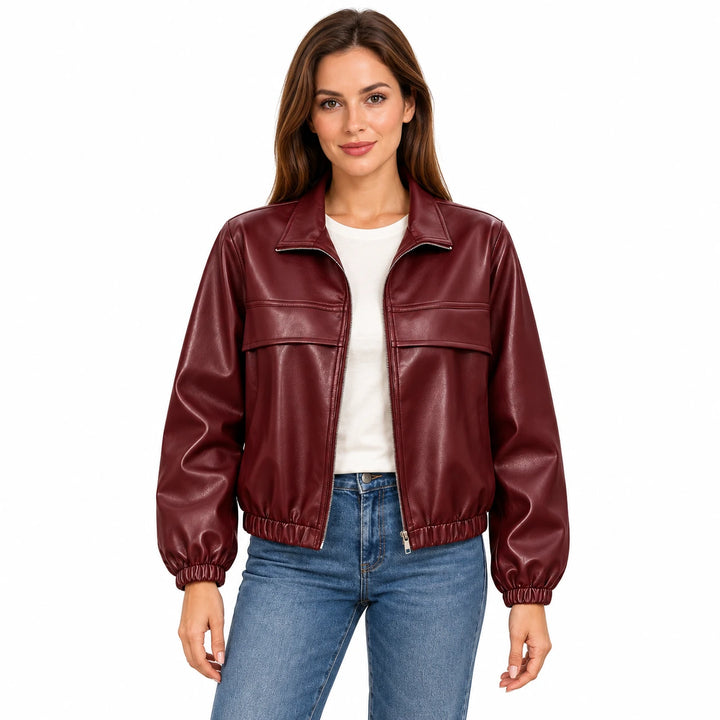 Woman wearing the Wine Red faux leather jacket with an ivory T-shirt and blue jeans on a white background.
