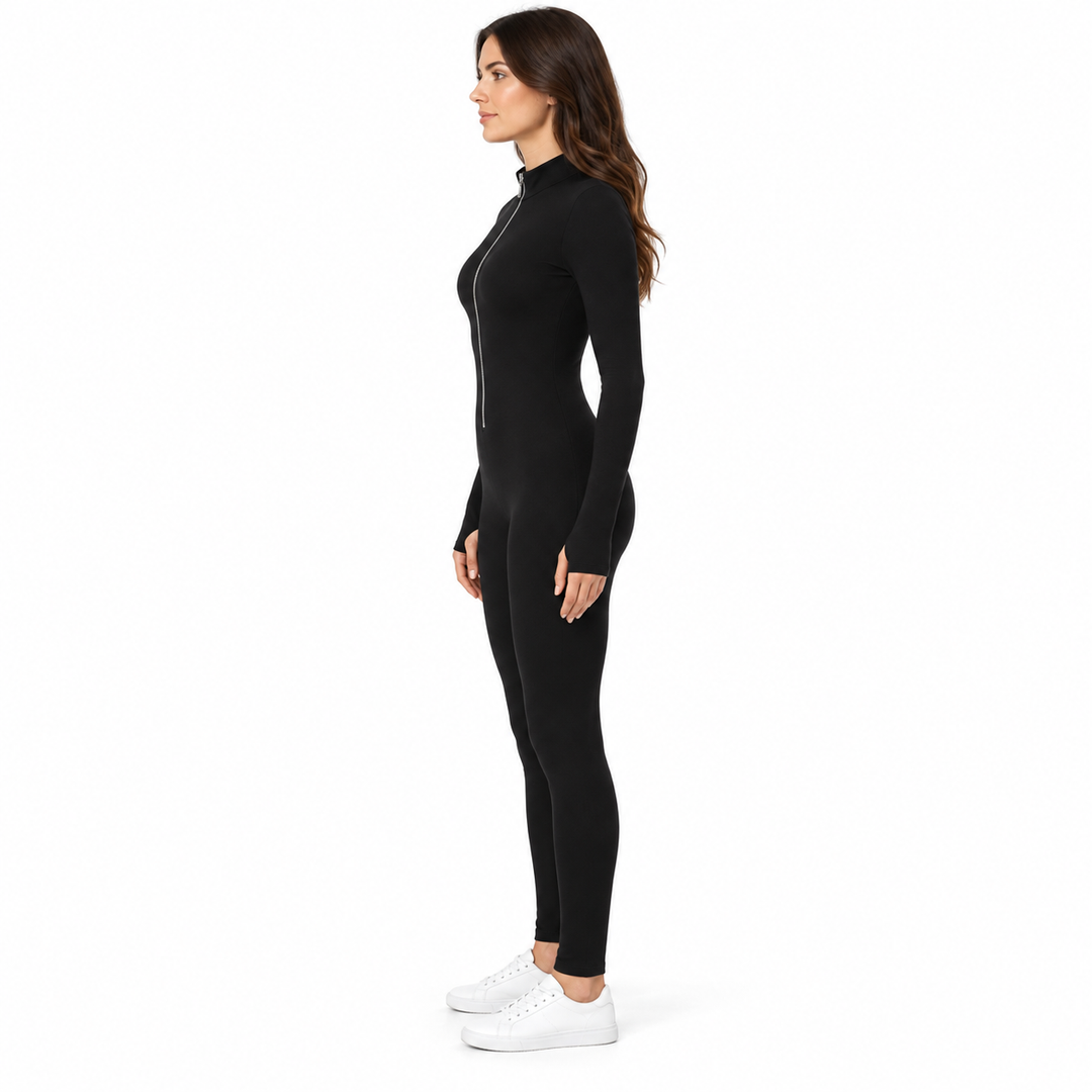 Side view of the black jumpsuit on an adult brunette model, showing a stand collar, long sleeves and fitted full-length legs.